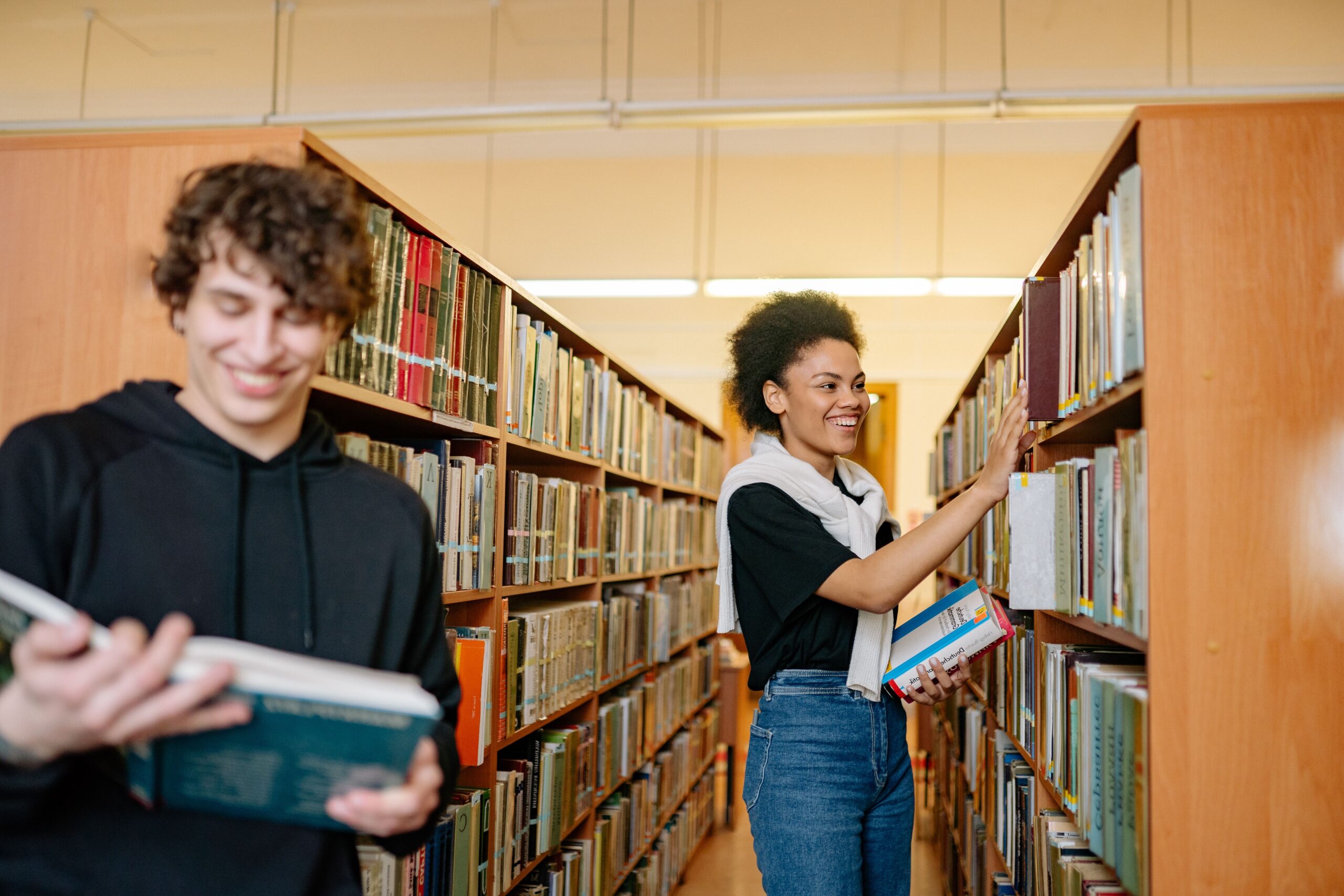 Two students standing in the library